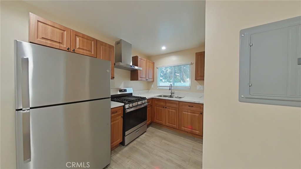 16609 Simonds Street Granada Hills, CA 91344 - Photo 2 of 7 a kitchen with stainless steel appliances granite countertop a refrigerator a stove a sink and a refrigerator