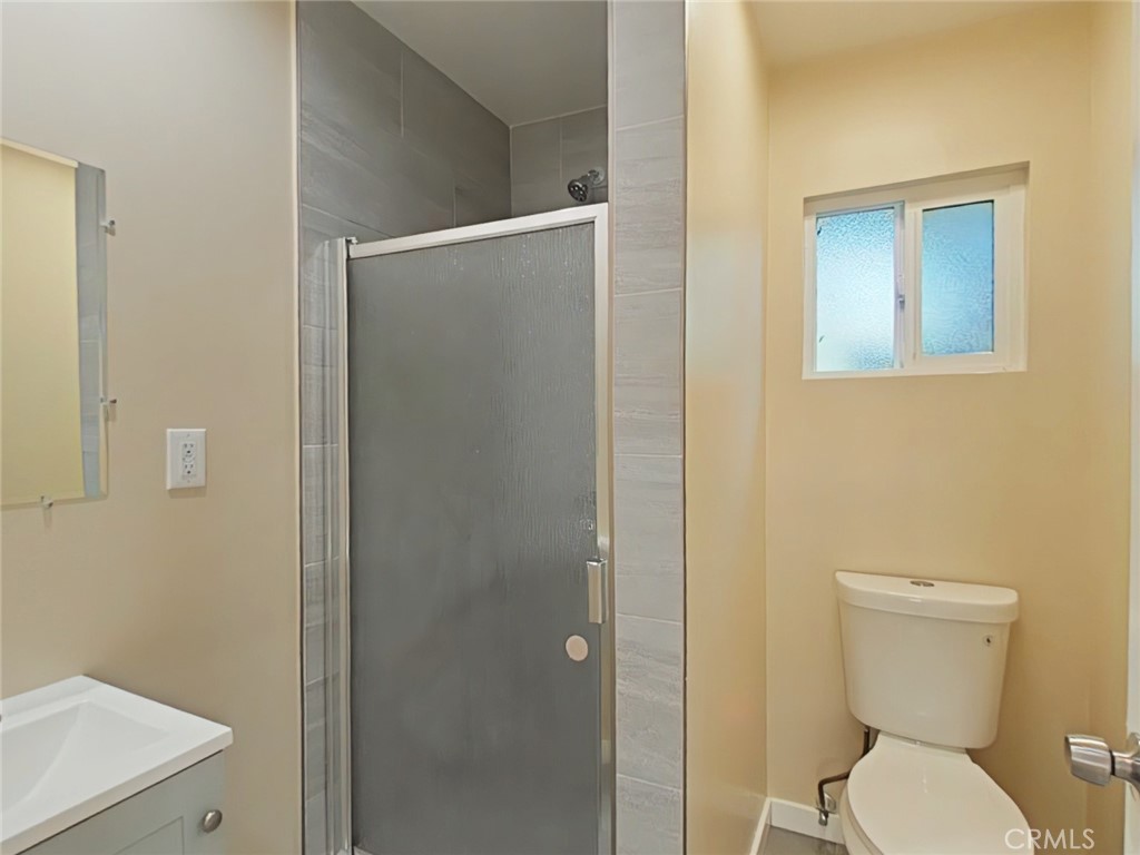 16609 Simonds Street Granada Hills, CA 91344 - Photo 6 of 7 a white toilet sitting next to a bathroom sink