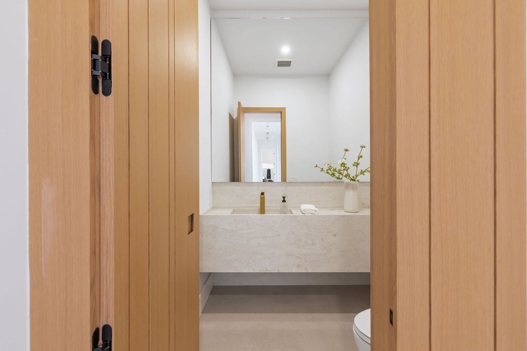 28 Cottonwood Road Newton, MA 02459 - Photo 9 of 25 a en suite bathroom with a sink and a mirror