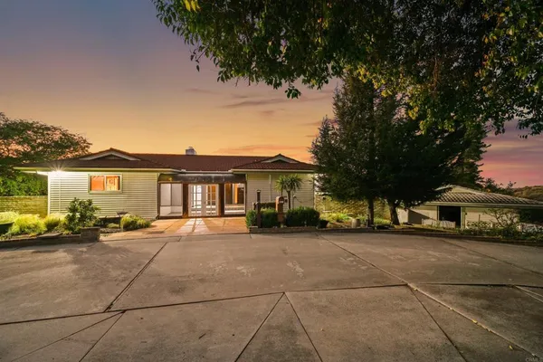 a view of a car park in front of house