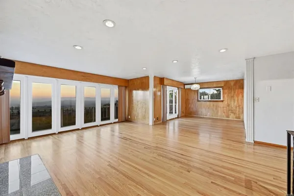a view of a living room a patio and a wooden floor