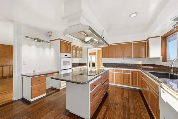 a kitchen with stainless steel appliances granite countertop a stove and a sink