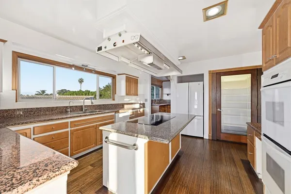 a kitchen with stainless steel appliances granite countertop a stove and a sink