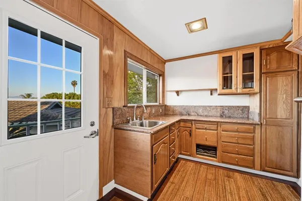 a bathroom with a granite countertop toilet sink and a mirror