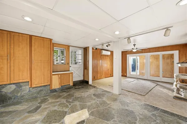 a bathroom with a granite countertop toilet sink and a mirror