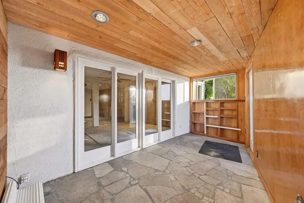 a view of backyard with wooden fence and trees