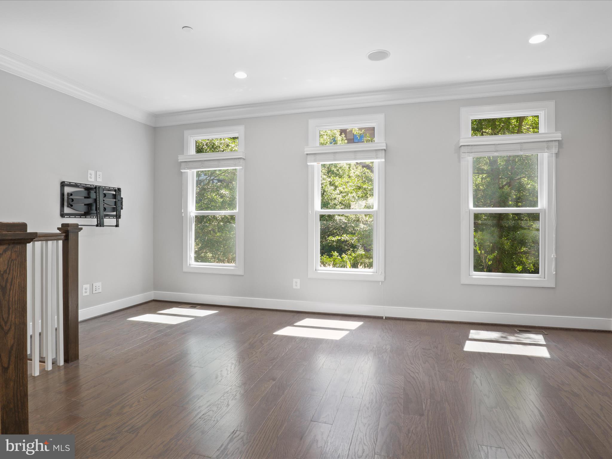1521 16th Road North Arlington, VA 22209 - Photo 14 of 59 a view of an empty room with wooden floor and a window