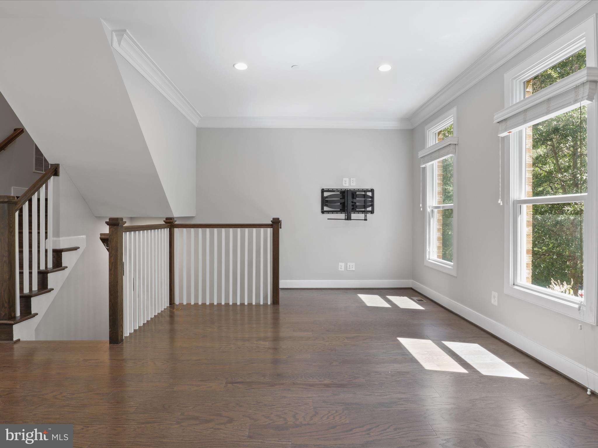 1521 16th Road North Arlington, VA 22209 - Photo 16 of 59 a view of an empty room with wooden floor and a window