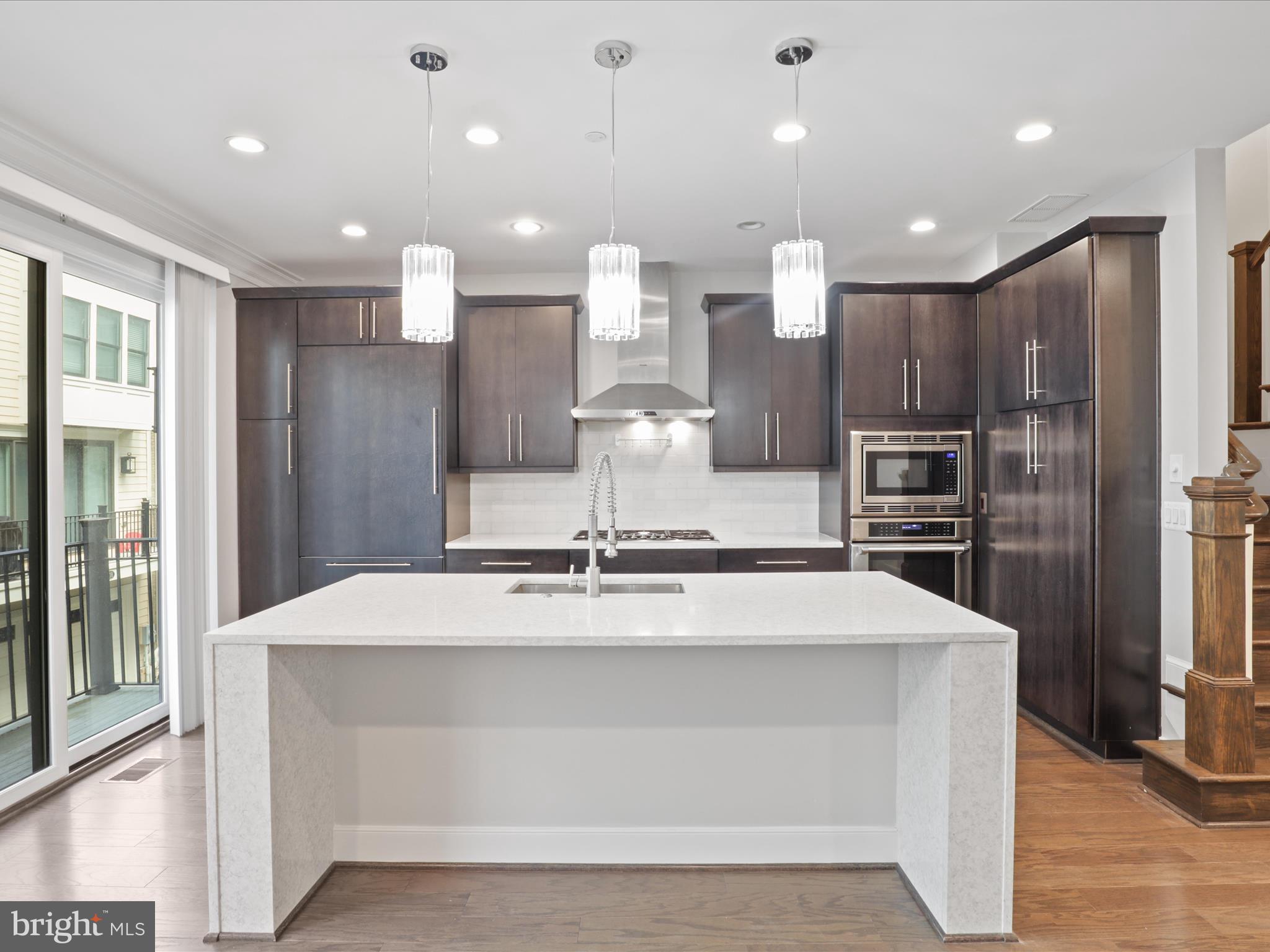 1521 16th Road North Arlington, VA 22209 - Photo 20 of 59 a large kitchen with stainless steel appliances kitchen island a large island in the center