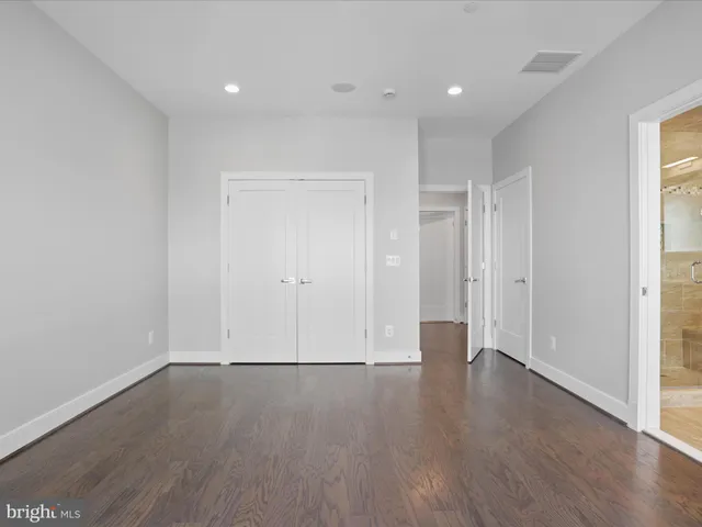 a bathroom with a granite countertop sink mirror and shower