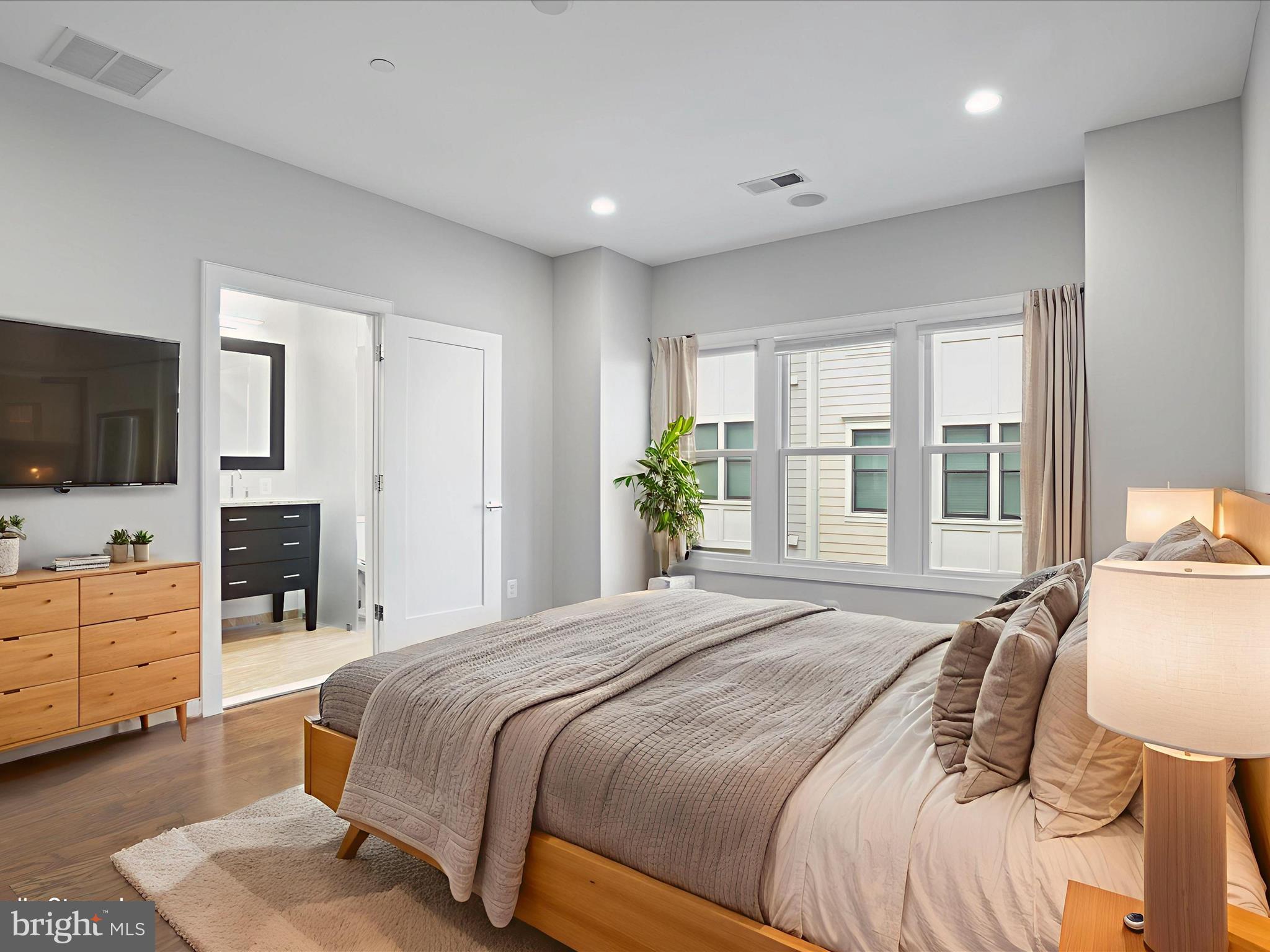 1521 16th Road North Arlington, VA 22209 - Photo 25 of 59 a bedroom with a large bed and flat tv screen