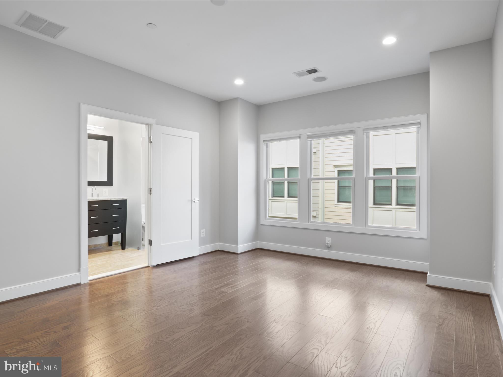 1521 16th Road North Arlington, VA 22209 - Photo 26 of 59 a view of an empty room with wooden floor and a window