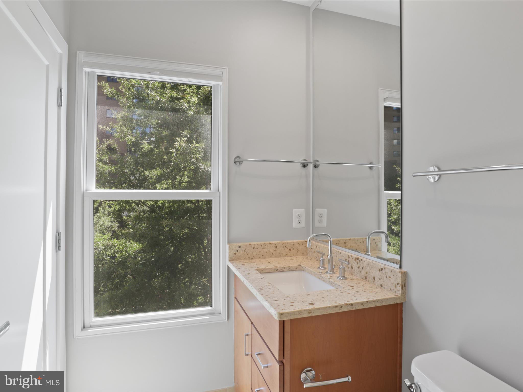 1521 16th Road North Arlington, VA 22209 - Photo 33 of 59 a bathroom with a granite countertop sink and a mirror