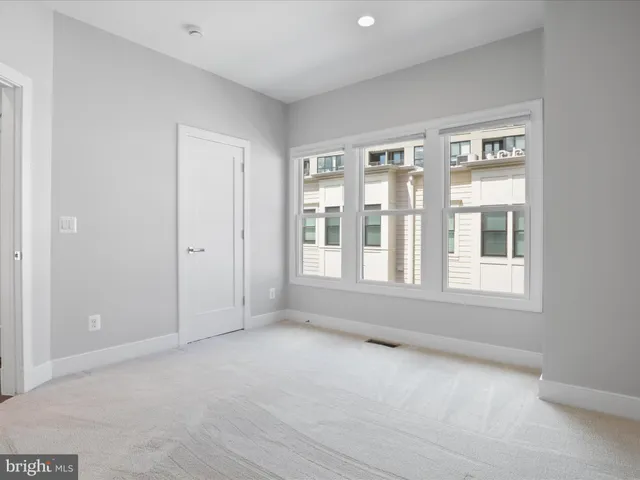 a view of a hallway with entryway and window