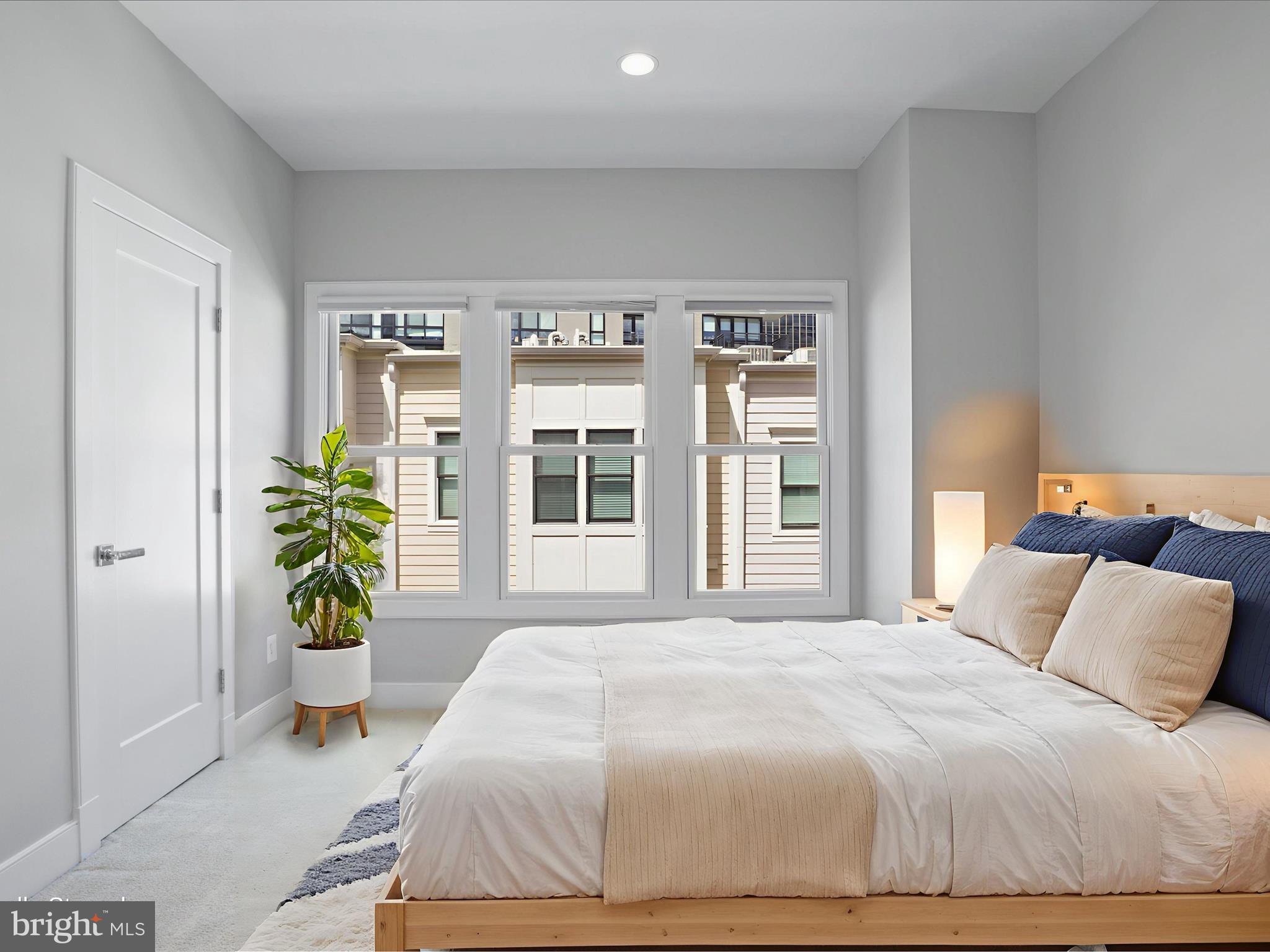 1521 16th Road North Arlington, VA 22209 - Photo 39 of 59 a bedroom with a bed and a potted plant