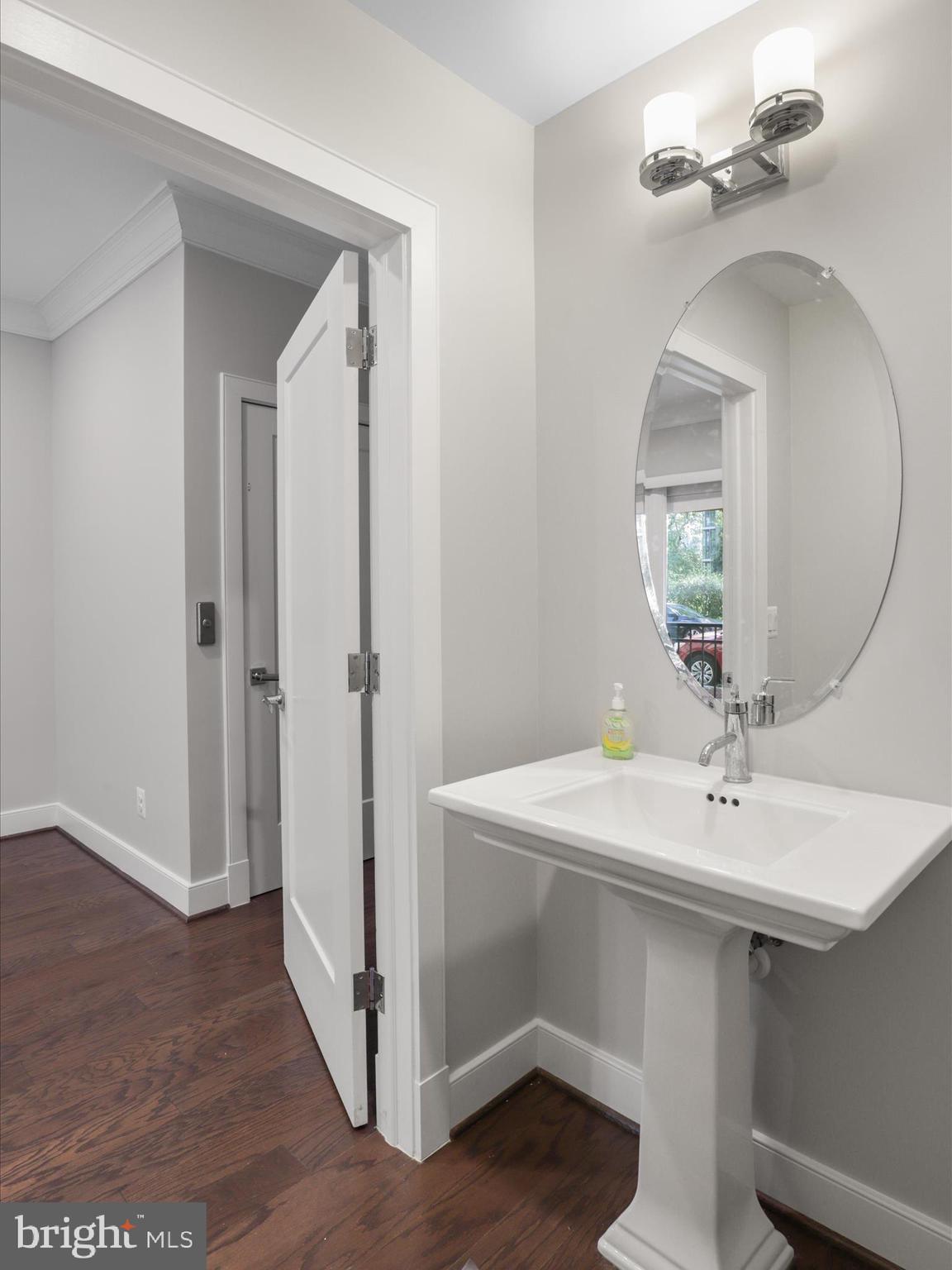 1521 16th Road North Arlington, VA 22209 - Photo 10 of 59 a bathroom with a sink a mirror and shower