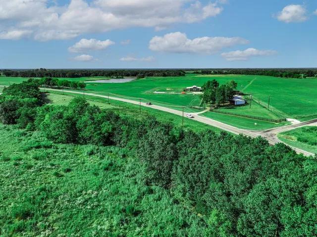 a view of a field with grass and a houses