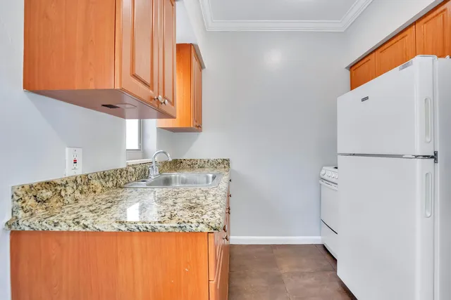 a view of kitchen cabinets and window
