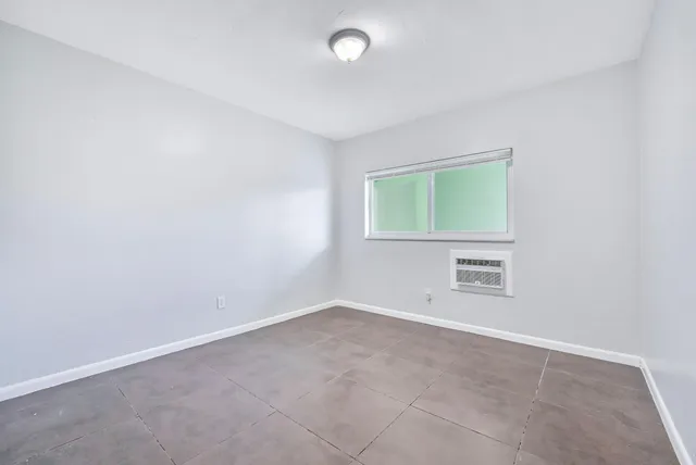 an empty room with a empty space and windows