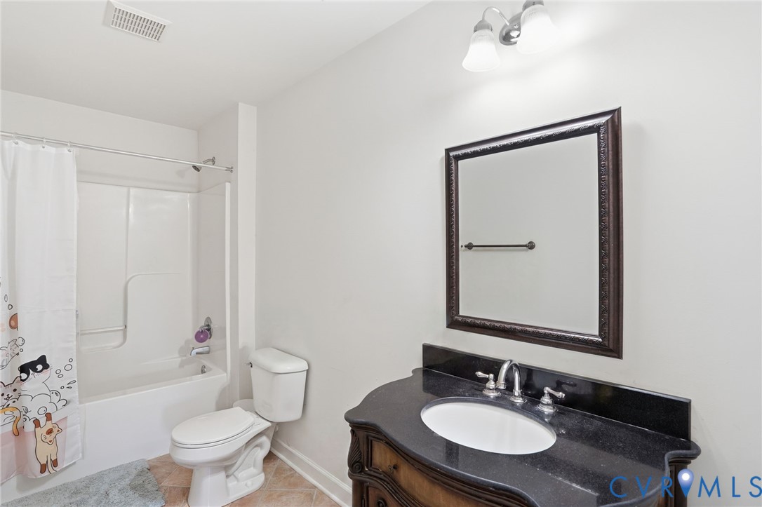 5305 Wellington Ridge Road Richmond, VA 23231 - Photo 49 of 67 Bathroom with a dark wood vanity, integrated sink,