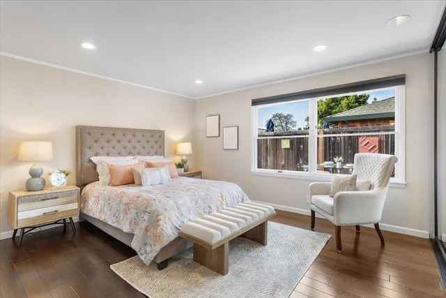 a bedroom with a bed and a large window