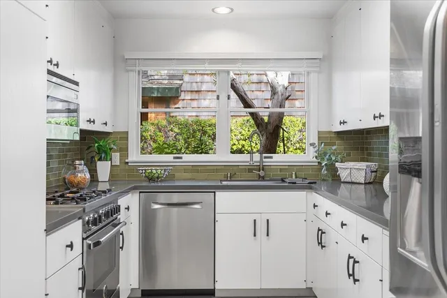 a kitchen with stainless steel appliances granite countertop a refrigerator and a sink
