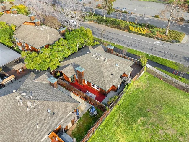 an aerial view of a house with a yard and potted plants