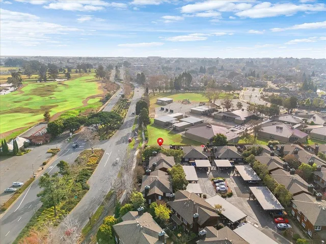 an aerial view of residential houses with outdoor space