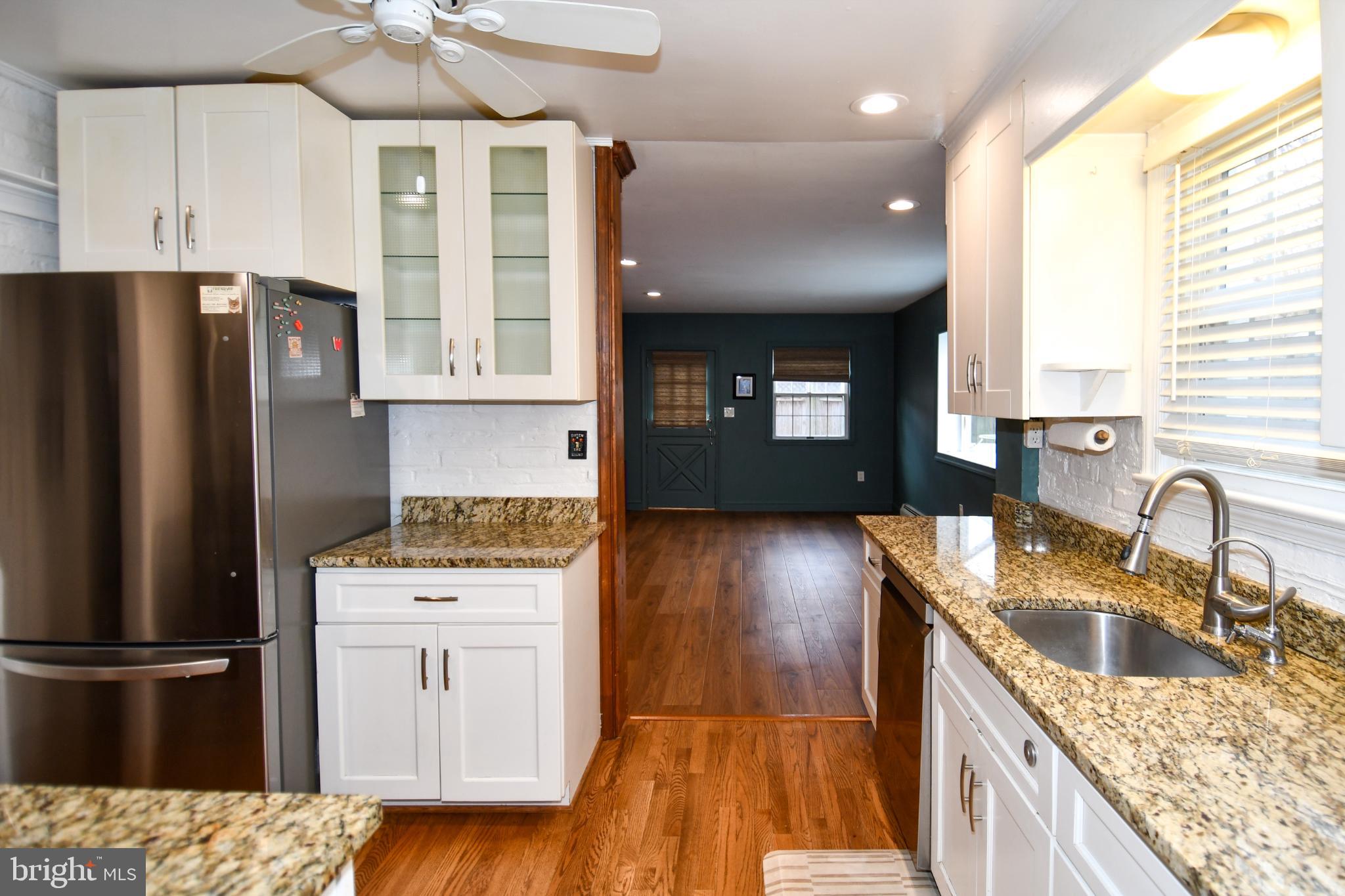 9325 Long Branch Parkway Silver Spring, MD 20901 - Photo 7 of 27 a kitchen with granite countertop a refrigerator stove and sink