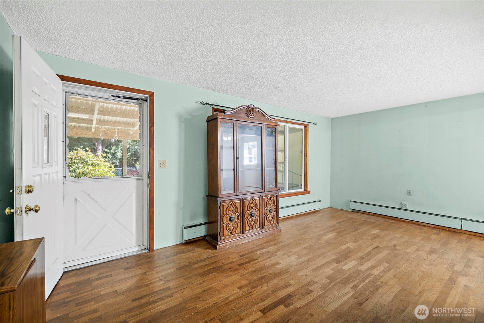 13435 Patriot Way Renton, WA 98059 - Photo 13 of 36 an empty room with wooden floor and windows