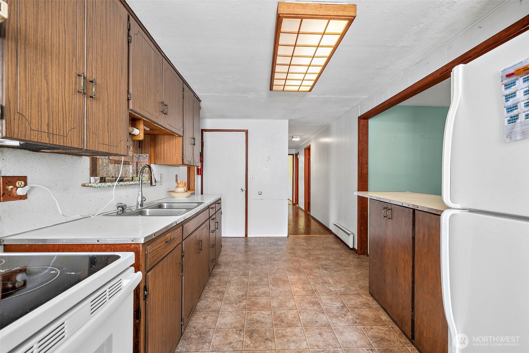 13435 Patriot Way Renton, WA 98059 - Photo 10 of 36 a kitchen with a sink stove and cabinets