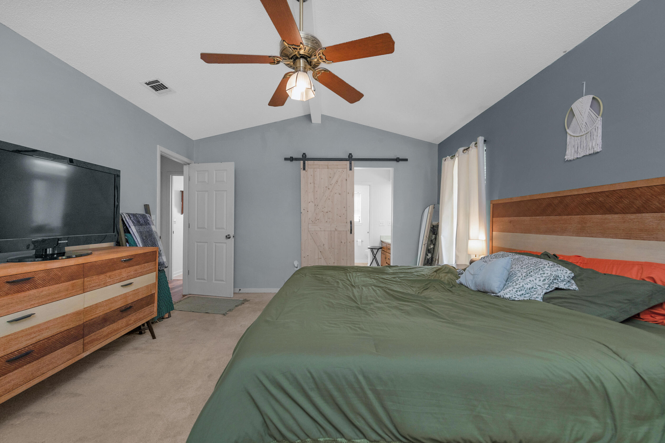 2788 Keats Drive Crestview, FL 32539 - Photo 17 of 32 a bedroom with a bed and a flat screen tv