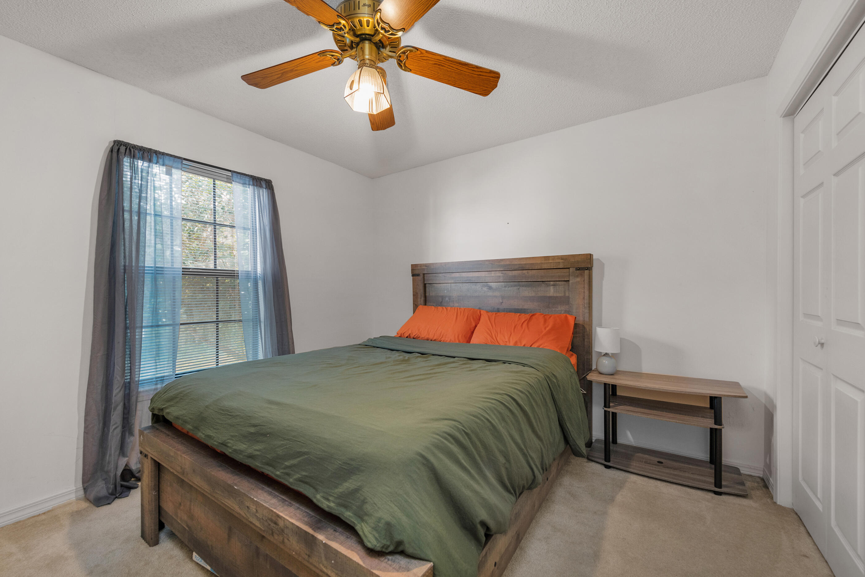 2788 Keats Drive Crestview, FL 32539 - Photo 18 of 32 a bedroom with a bed and a chandelier