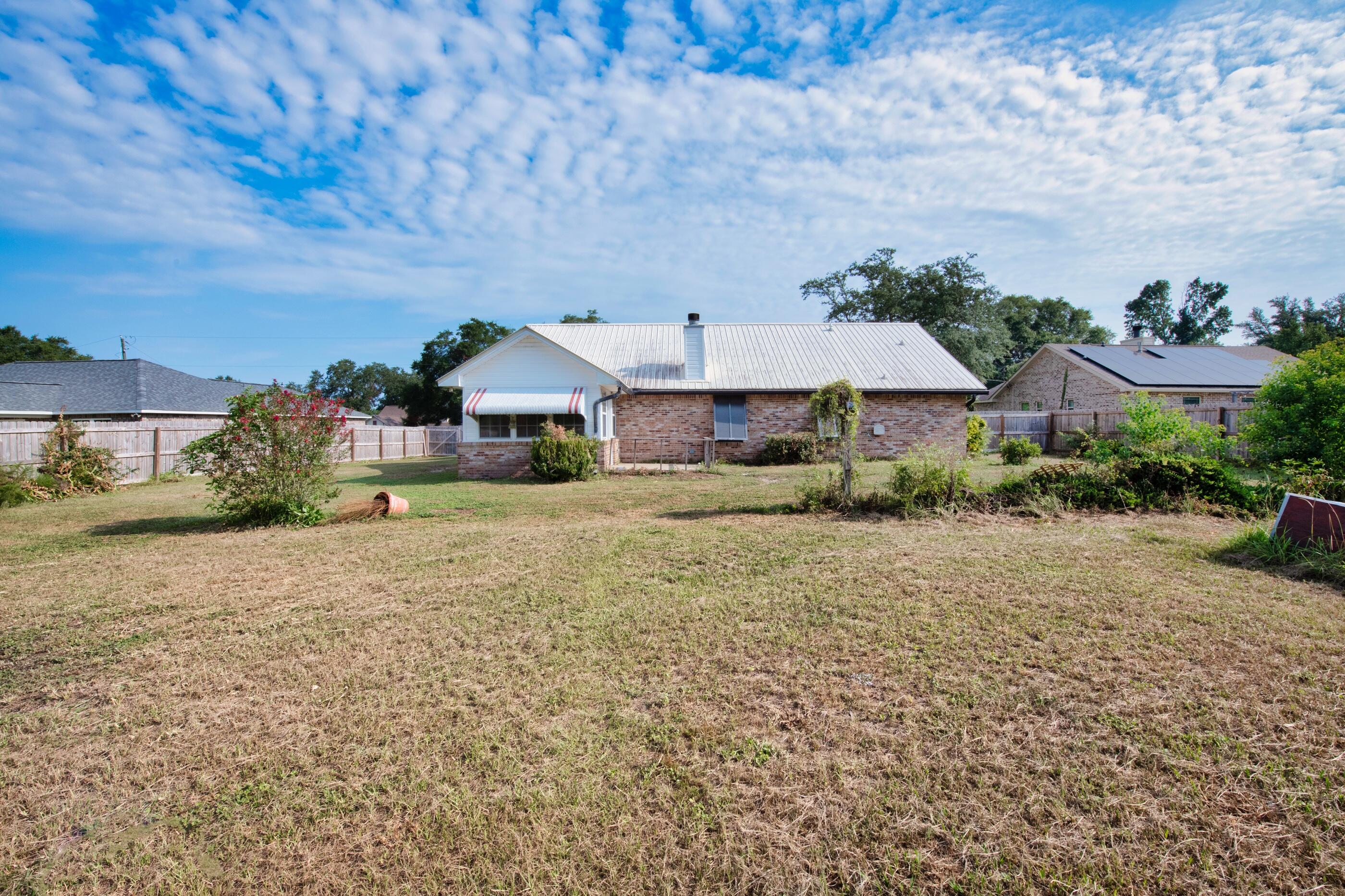 2788 Keats Drive Crestview, FL 32539 - Photo 30 of 32 a front view of house with yard and trees in the background