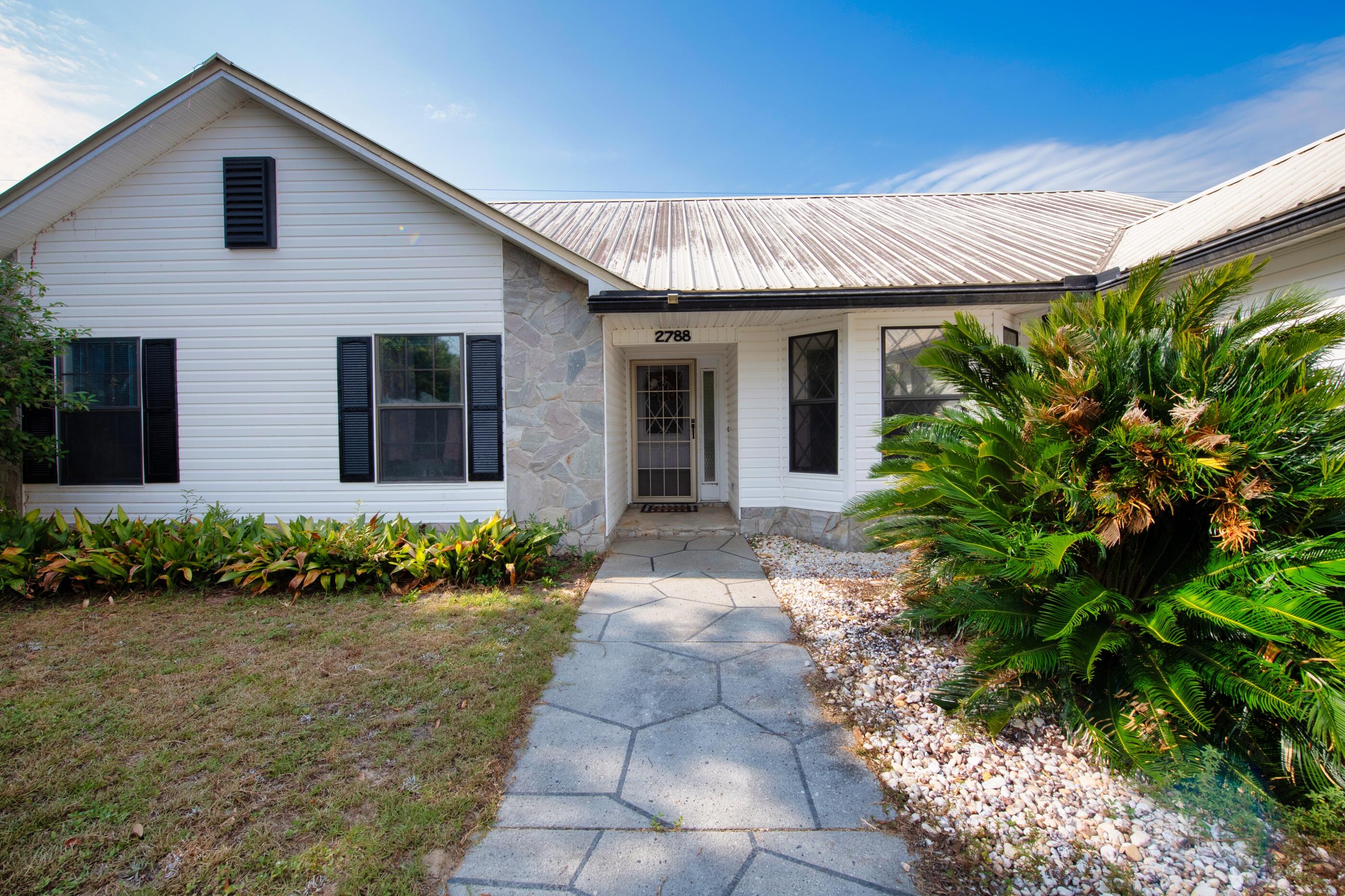 2788 Keats Drive Crestview, FL 32539 - Photo 4 of 32 a front view of a house with garden