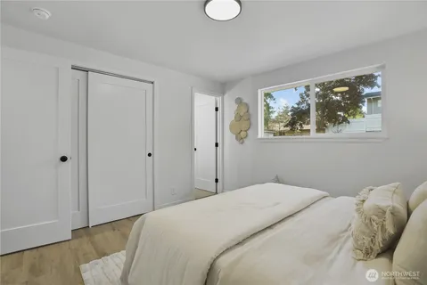 a bedroom with a bed and a window