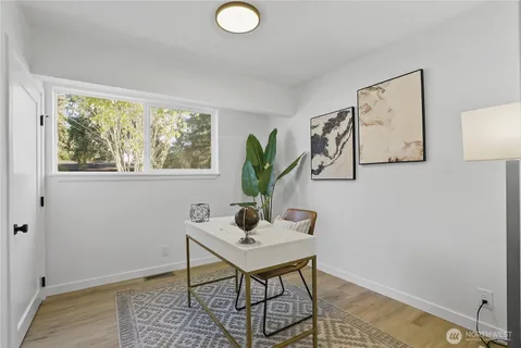 a view of a workspace with furniture and a window