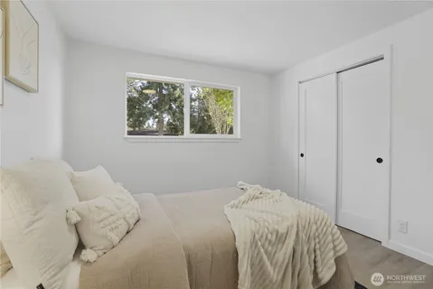 a bedroom with a bed and a window