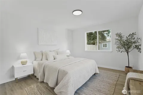 a bedroom with a bed and a potted plant