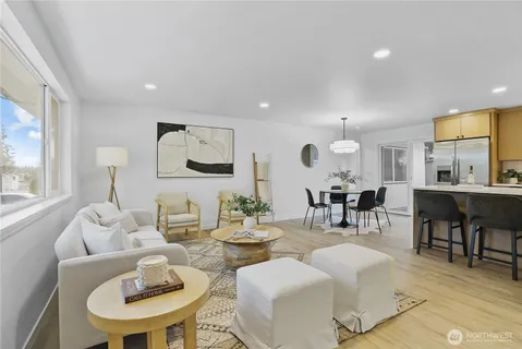 a living room with furniture kitchen and a table