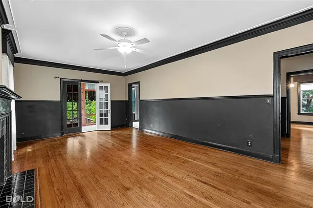 a view of a livingroom with an empty room and wooden floor