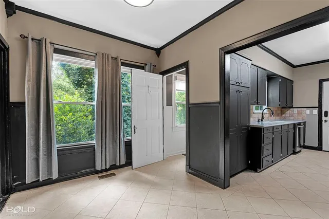 a view of a open kitchen with a refrigerator cabinets and a wooden floor