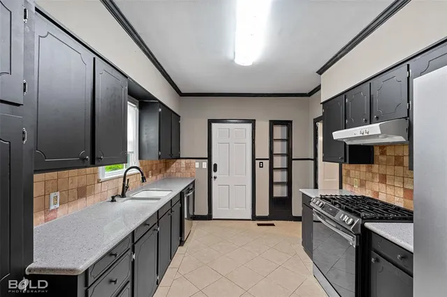 a kitchen with refrigerator a stove and cabinets