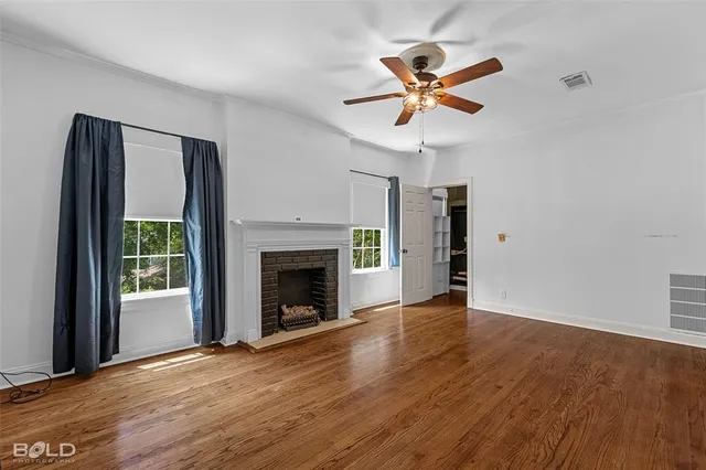 a view of a livingroom with a ceiling fan and wooden floor
