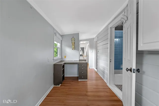 a kitchen with granite countertop a sink and wooden floor