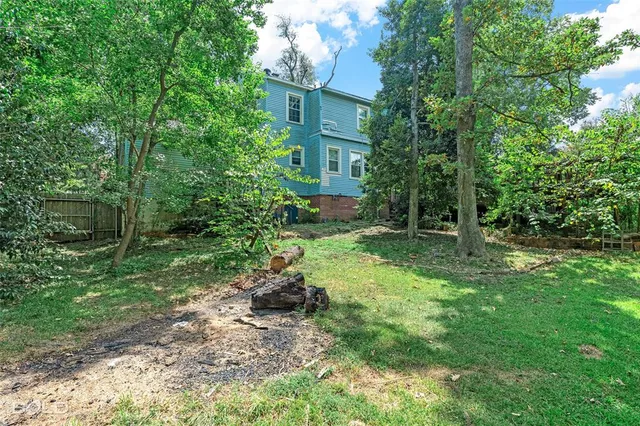 a view of backyard of house with green space