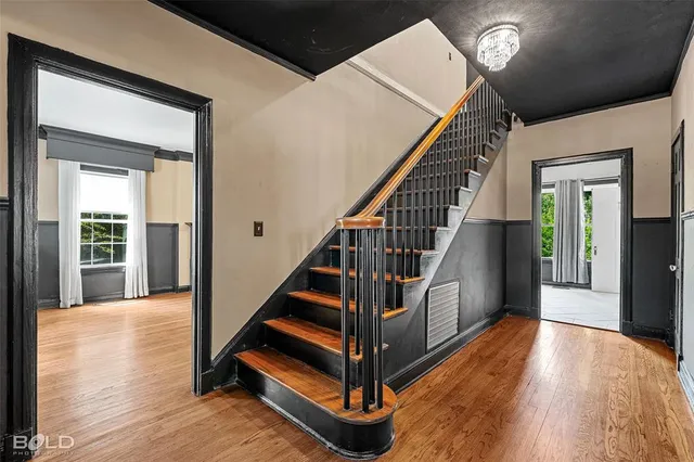 a view of entryway with wooden floor and stairs