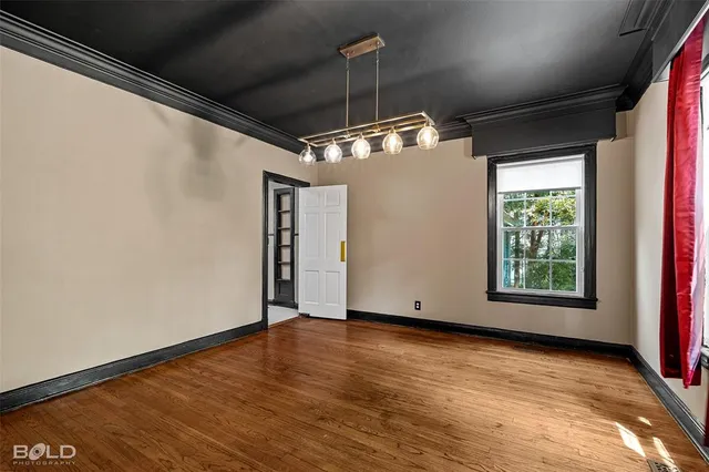 a view of a room with wooden floor and window