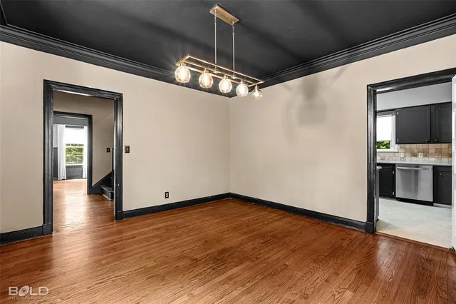 a view of a kitchen with wooden floor and a sink