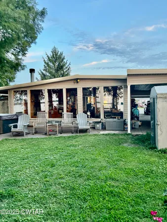a view of a house with backyard porch and sitting area